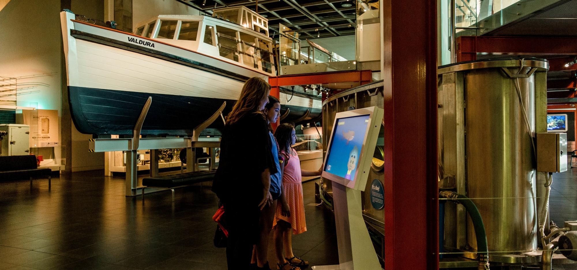 In the centre of the Museum ground floor is a walkway surrounded by boats suspended in the air.